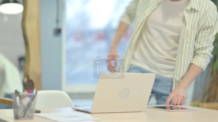 Photo for Young Man Coming Back to Office for Work - Royalty Free Image