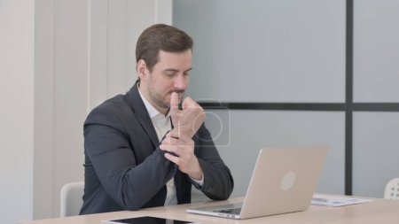 Photo for Businessman having Wrist Pain while using Laptop - Royalty Free Image