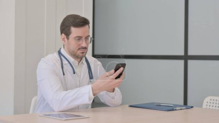 Téléchargez les photos : Médecin Naviguer sur Smartphone dans Clinique - en image libre de droit