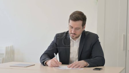 Photo for Businessman Working on Documents, Calculating and Counting Dollar - Royalty Free Image