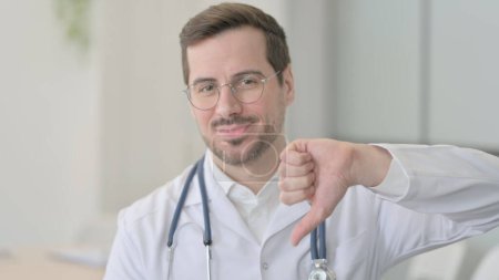 Photo for Portrait of Male Doctor Doing Thumbs Down - Royalty Free Image