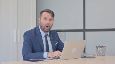 Photo for Shocked Businessman Working on Laptop - Royalty Free Image