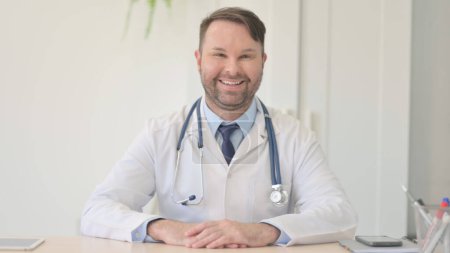 Photo for Smiling Young Doctor Looking at Camera in Clinic - Royalty Free Image