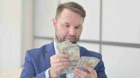 Photo for Portrait of Businessman Counting Dollars, Money Making - Royalty Free Image