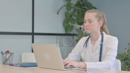 Photo for Female Doctor Working on Laptop in Clinic - Royalty Free Image
