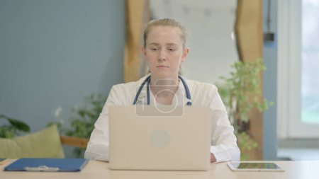 Photo for Female Doctor Working on Laptop in Clinic - Royalty Free Image