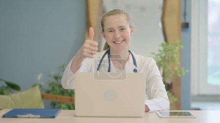 Photo for Thumbs Up by Female Doctor on Laptop in Clinic - Royalty Free Image