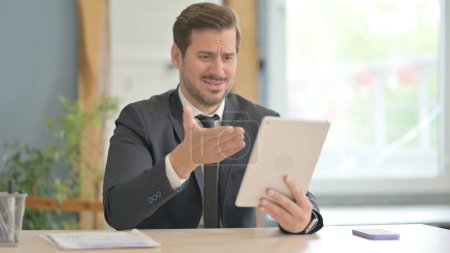Businessman Upset by Loss on Tablet
