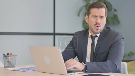 Photo for Shocked Businessman Working on Laptop - Royalty Free Image