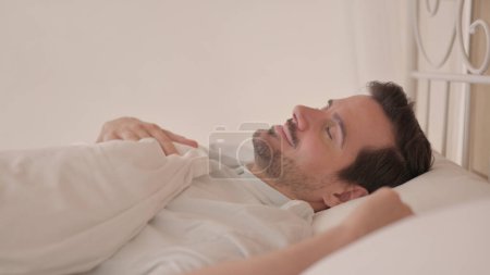 Photo for Side View of Tired Young Man Going to Bed - Royalty Free Image