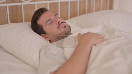 Photo for Young Man Waking Up and Leaving Bed - Royalty Free Image