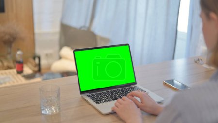 Photo for Young Woman Using Laptop with Green Screen - Royalty Free Image