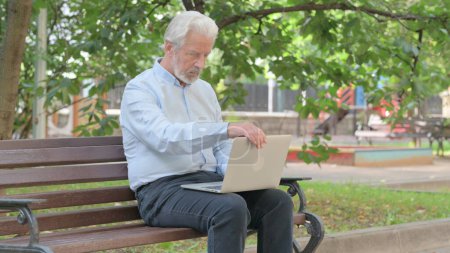Photo for Senior Old Man Leaving Bench Outdoor after Working on Laptop - Royalty Free Image