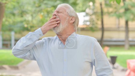 Photo for Outdoor Portrait of Yawning Senior Old Man - Royalty Free Image