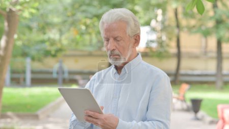 Téléchargez les photos : Vieil homme âgé utilisant Tablet Outdoor - en image libre de droit
