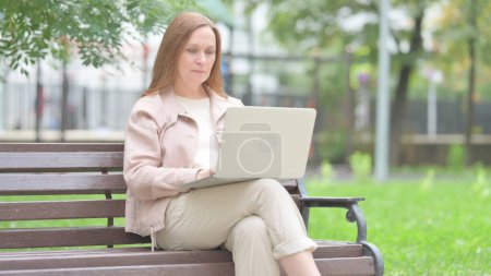 Photo for Senior Old Woman Working on Laptop Outdoor - Royalty Free Image