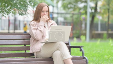 Photo for Coughing Senior Old Woman Using Laptop Outdoor - Royalty Free Image