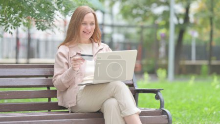 Photo for Senior Old Woman Excited for Successful Online Shopping on Laptop Outdoor - Royalty Free Image