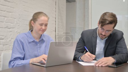 Photo for Businesswoman Talking with Businessman in Office - Royalty Free Image