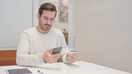 Photo for Excited Young Man Enjoying Online shopping on Smartphone - Royalty Free Image