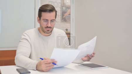 Photo for Middle Aged Man Working on Documents in Office - Royalty Free Image