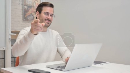 Photo for Young Man Pointing at Camera in Office - Royalty Free Image