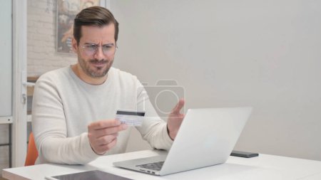 Foto de Hombre de mediana edad molesto con problemas de compras en línea en el ordenador portátil - Imagen libre de derechos
