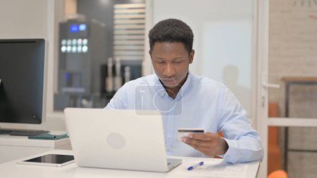 Photo for African Businessman Enjoying Online Shopping on Laptop - Royalty Free Image