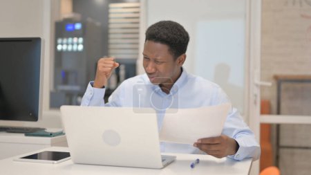 Photo for African Businessman Feeling Upset with Contract at Work - Royalty Free Image