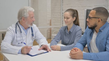 Photo for Senior Doctor Discussing Medical Report with Patient - Royalty Free Image