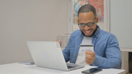 Photo for African Businessman Shopping Online on Laptop in Office - Royalty Free Image