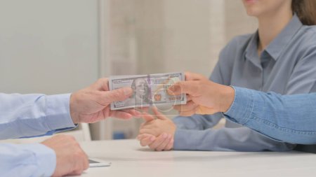 Photo for Close up of Senior Man Getting Paid Money from a Couple - Royalty Free Image