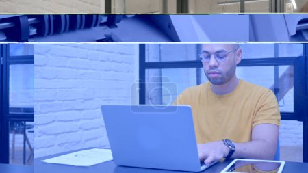 Téléchargez les photos : Hispanique homme travaillant sur ordinateur portable dans le bureau - en image libre de droit