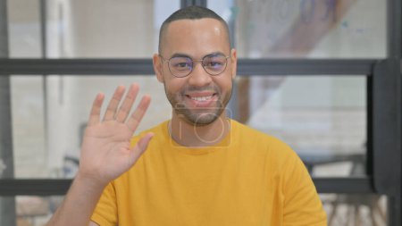 Photo for Portrait of Mixed Race Man Waving Hand to Say Hello - Royalty Free Image