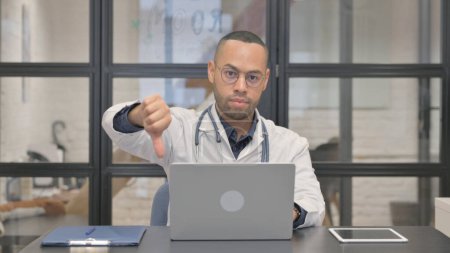 Thumbs Down by Mixed Race Doctor at Work