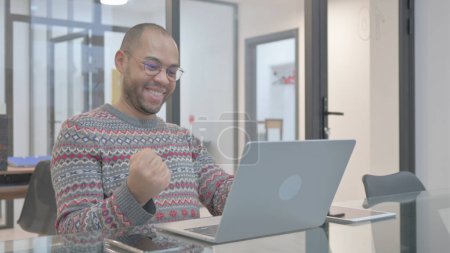 Photo for Excited Young Hispanic Man Celebrating Success on Laptop - Royalty Free Image
