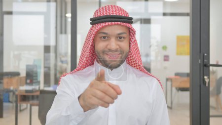 Photo for Portrait of Young Muslim Man Pointing at Camera - Royalty Free Image