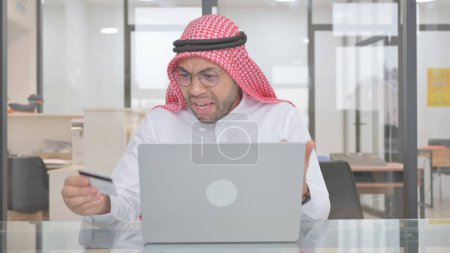 Téléchargez les photos : Défaillance bancaire en ligne pour un jeune musulman, carte de crédit - en image libre de droit