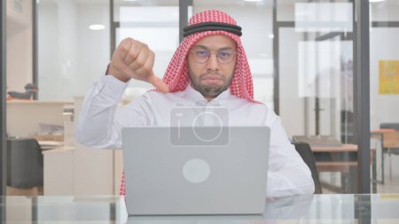 Photo for Thumbs Down by Young Muslim Man at Work - Royalty Free Image