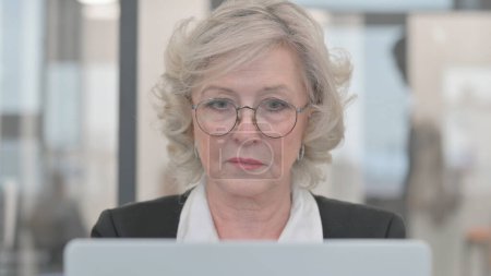 Photo for Close up of Senior Businesswoman Working on Laptop - Royalty Free Image