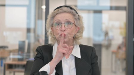 Téléchargez les photos : Portrait de femme d'affaires senior avec doigt sur les lèvres, Silence Please - en image libre de droit