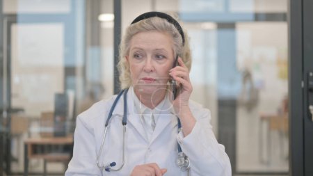 Photo for Portrait of Senior Female Doctor Talking on Phone - Royalty Free Image