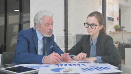 Photo for Business People Discussing Business Report at Work - Royalty Free Image