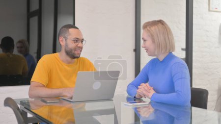 Photo for Mixed Race Man Talking with Female Worker in Office - Royalty Free Image