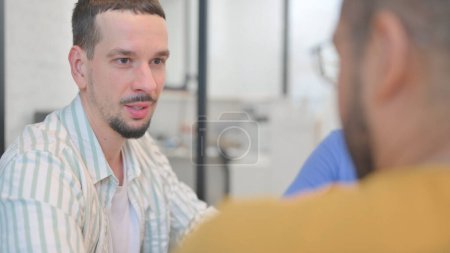 Photo for Close up of Young Man Talking with Teammates - Royalty Free Image