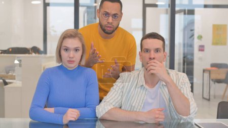 Photo for Portrait of Mixed Race Teammates Reacting to Failure in Office - Royalty Free Image