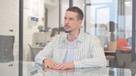 Photo for Angry Creative Young Man Sitting in Office - Royalty Free Image