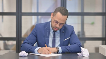 Photo for Mixed Race Businessman Struggling to Write a Letter - Royalty Free Image