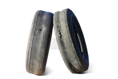 Photo for Old worn out tire next to another old tire isolated on white background as sample of damaged tires from some tires - Royalty Free Image