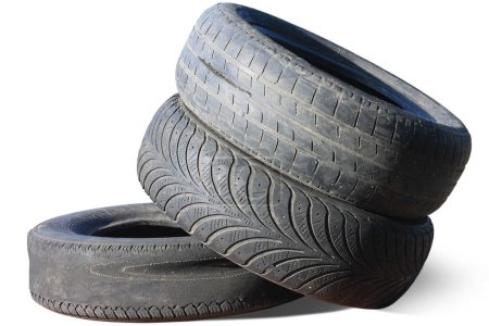 Photo for Old worn out tire next to another old tire isolated on white background as sample of damaged tires from some tires - Royalty Free Image